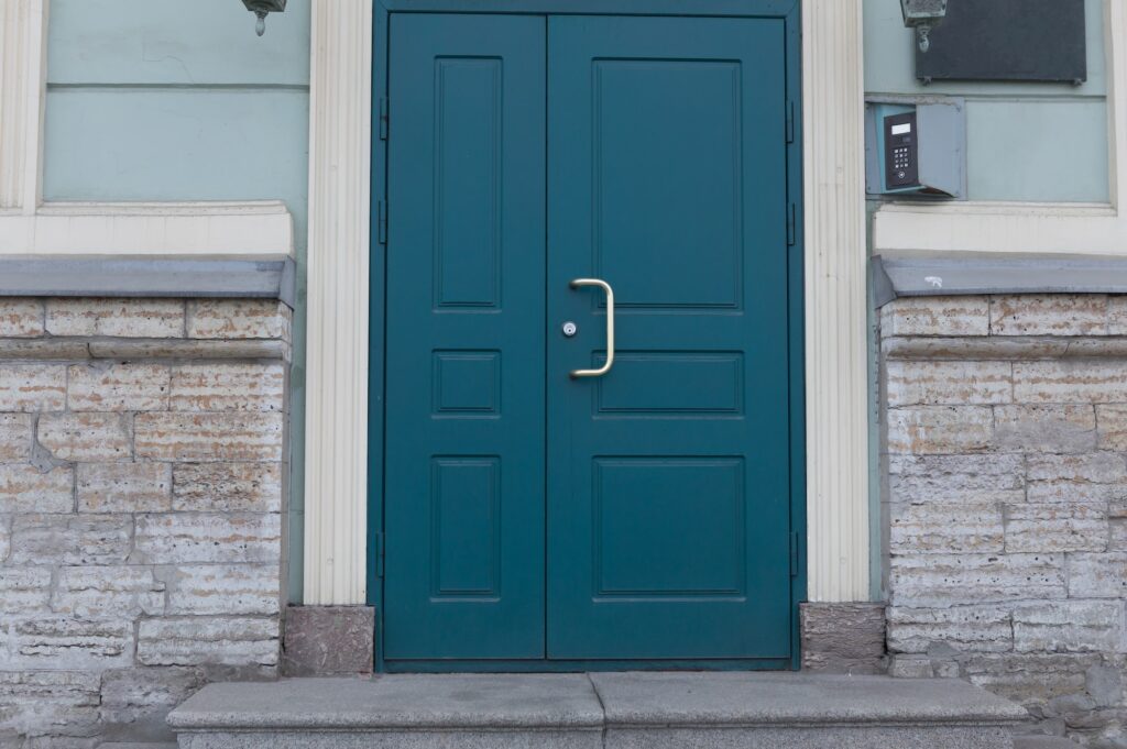 Old vintage green door. Abstract exterior and interior around the entrance. Doors of city houses.